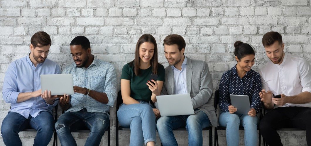 Professionals engaging on LinkedIn with laptops and phones